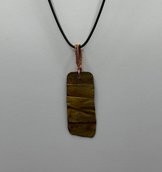 Fold formed, textured and heat coloured copper pendant